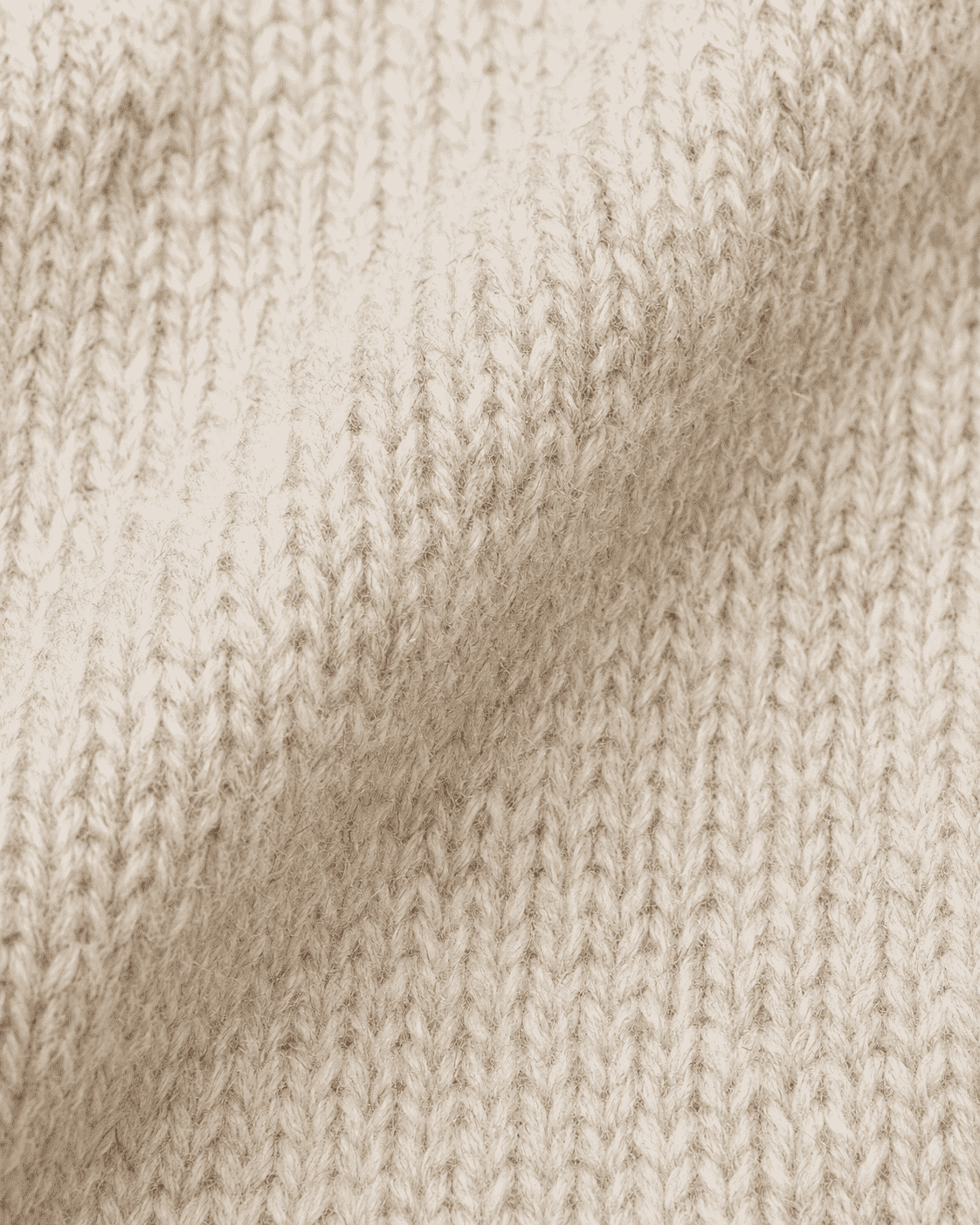 Close-up of a cream-colored knit fabric 